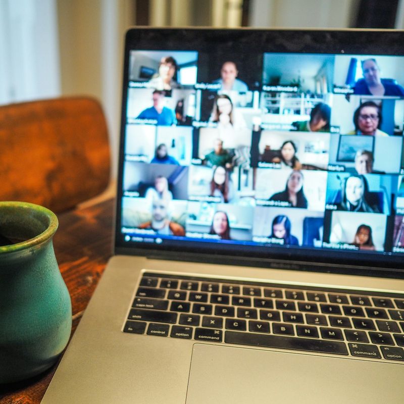 Laptop on a kitchen table showing a family video call